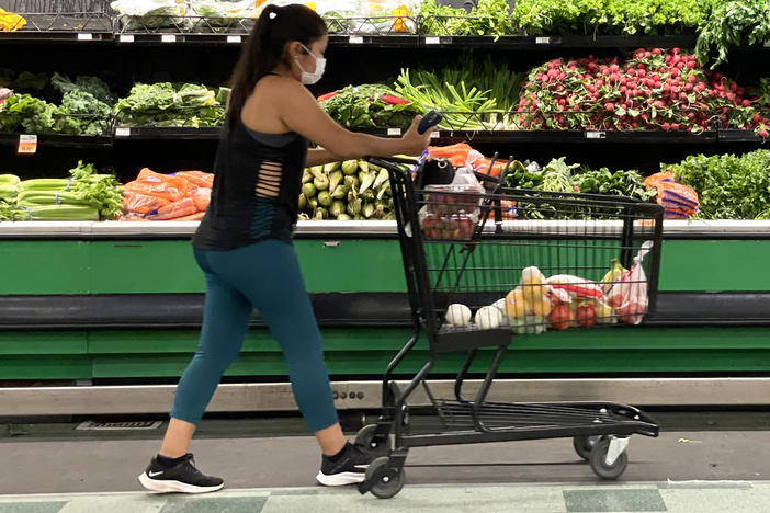 A customer shops at a grocery store in San Rafael, Calif., on June 8. Inflation has surged to its highest rate in nearly 40 years, and Americans are having to adjust some of their spending patterns.
