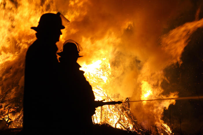 Firefighter extinguish a fire at night