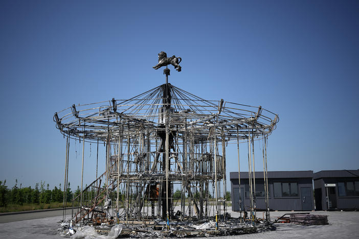 The remains of a carousel destroyed during the Russian invasion stand on the grounds of Dobropark, a children's theme park on the outskirts of Kyiv, on Friday. The park will reopen next week.