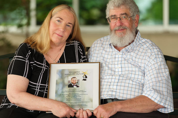 Mary Rich, shown with her husband, Joel, at their home in Omaha, Neb., says self-promoters they trusted to help solve the killing of their son took advantage of them. "You're a total sucker," Mary Rich says. "I think every day: Who's going to bug us? What's coming at us? I will always think that."