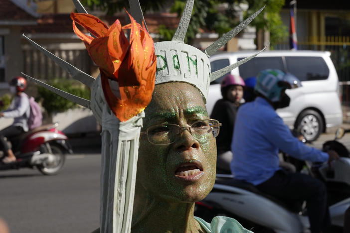 Cambodian-American lawyer Theary Seng, dressed in the Lady Liberty talks to the media outside Phnom Penh Municipal Court in Phnom Penh, Cambodia, Tuesday, June 14, 2022.