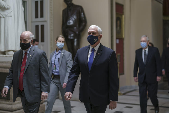 After violent protesters loyal to President Donald Trump stormed the U.S. Capitol on Jan. 6, Vice President Mike Pence leads senators to the House chamber to continue the joint session of the House and Senate and count the Electoral College votes cast in November's election.