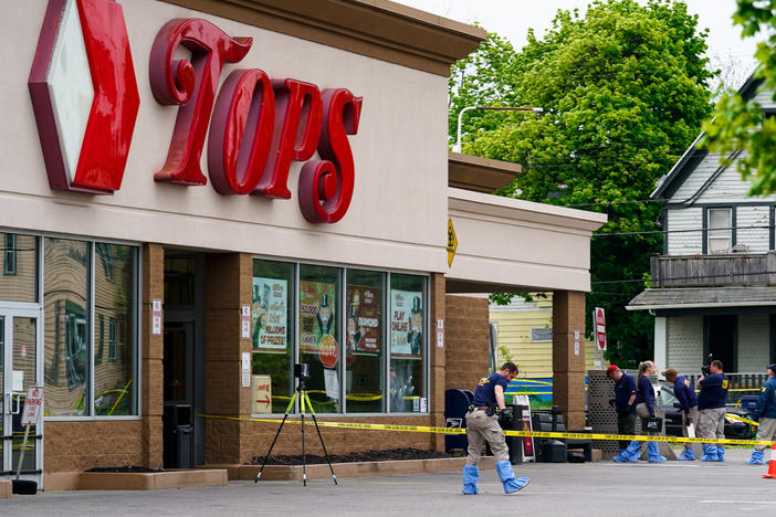 Investigators work the scene last month after the mass shooting at a supermarket in Buffalo, N.Y.