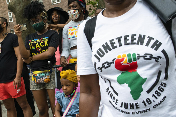 People attend Juneteenth celebrations in the Harlem neighborhood of New York, on June 19, 2021.