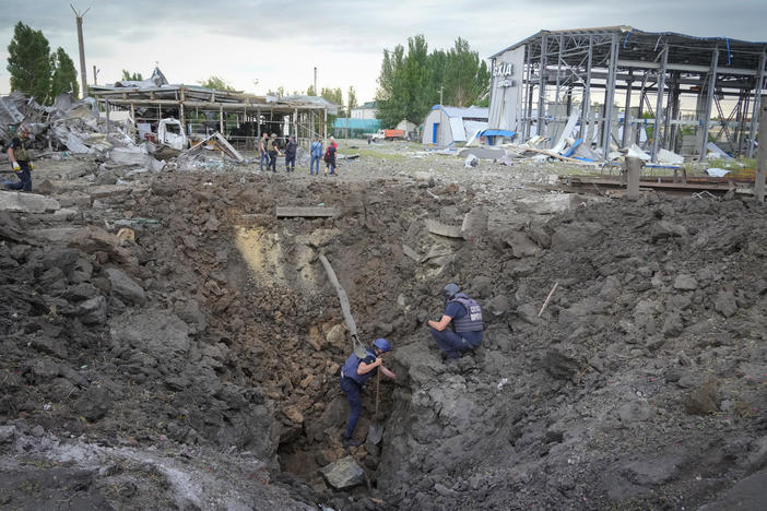 Police inspect a crater caused by a Russian rocket attack in Pokrovsk, in eastern Ukraine's Donetsk region, on Wednesday.