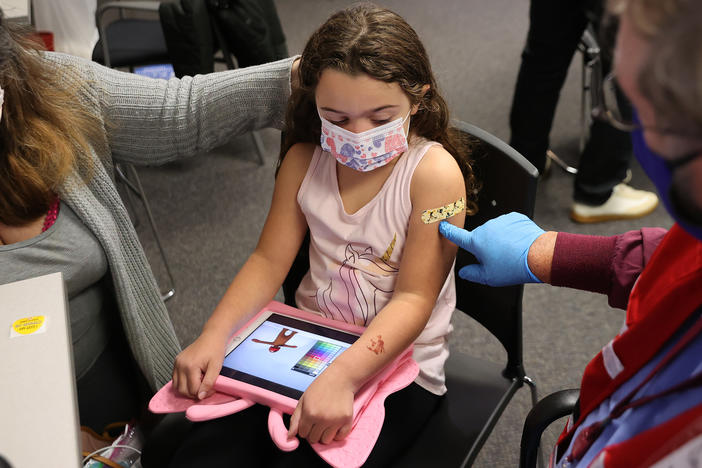 A child receives the Pfizer BioNTech COVID-19 vaccine at the Fairfax County Government Center in Annandale, Va.,  in November 2021. A committee of advisers to the Food and Drug Administration recommended Wednesday that the agency expand authorization of COVID-19 vaccines to children as young as 6-months-old.