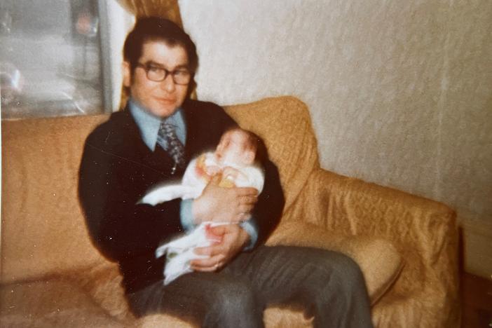 Constantine Tsioulcas, holding his daughter Anastasia as a baby.