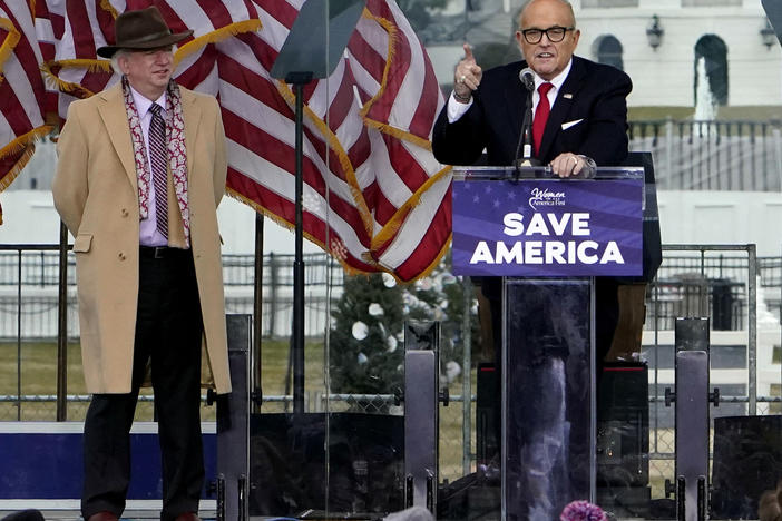 John Eastman, left, listens as former New York Mayor Rudy Giuliani speaks at the Jan. 6, 2021, "Save America" rally that preceded the attack on the U.S. Capitol.