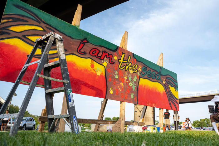 Juneteenth, or Emancipation Day, commemorates the end of slavery on June 19, 1865, in Galveston, Texas, in compliance with President Lincoln's 1863 Emancipation Proclamation. Here, a young woman stands near a piece of art created during the Louisville Juneteenth Festival at the Big Four Lawn on June 19, 2021, in Louisville, Ky.