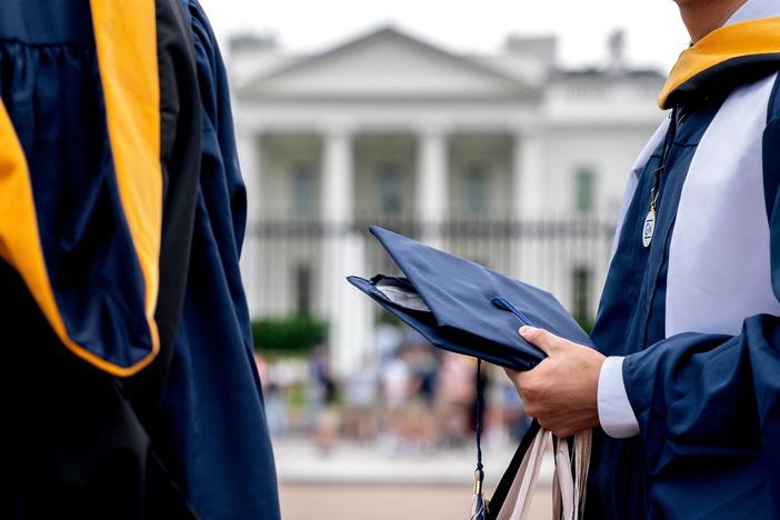 Students from George Washington University wear their graduation gowns outside the White House in May.