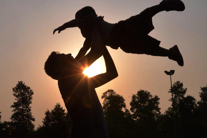 A father plays with his son at a park in Amritsar, India, on Father's Day in June 2016.