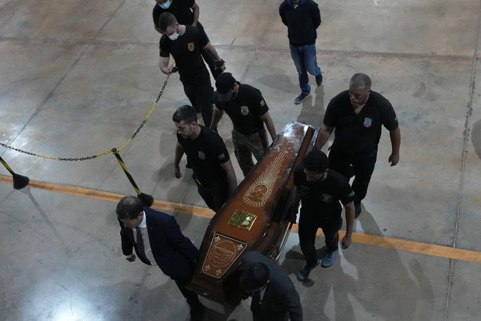 Federal police officers arrive with recovered human remains believed to be of the Indigenous expert Bruno Pereira of Brazil and freelance reporter Dom Phillips of Britain, at the federal police hangar in Brasília, Brazil on Thursday.