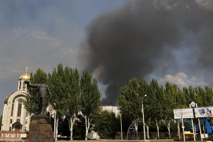 Smoke rises from a burning house following shelling in Donetsk, eastern Ukraine, on Friday.