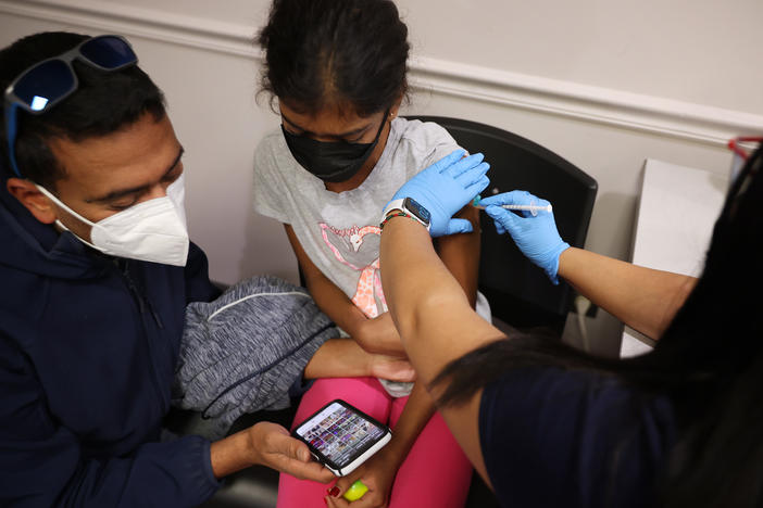 A child receives the Pfizer BioNTech vaccine at the Fairfax County Government Center in Annandale, Va., last November. Vaccines will soon be available for children as young as 6 months old.