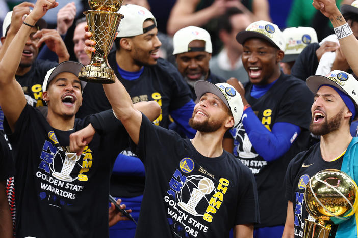 Stephen Curry raises the NBA Finals Most Valuable Player Award after the Golden State Warriors defeated the Boston Celtics 103-90 in Game 6 of the 2022 NBA Finals on June 16, 2022 in Boston.