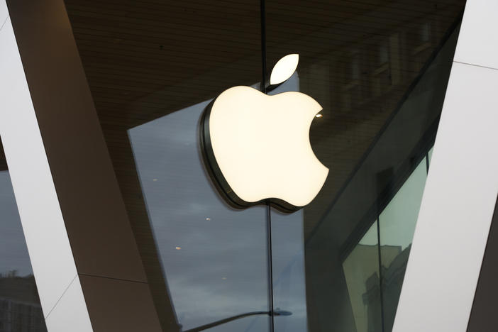 FILE - The Apple logo adorns the facade of a retail store. More than 100 employees of an Apple store in a suburb of Baltimore voted to unionize by a nearly 2-to-1 margin Saturday, June 18, 2022.