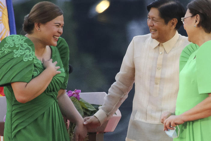Philippine Vice President-elect Sara Duterte, left, is greeted by incoming Philippine President Ferdinand "Bongbong" Marcos Jr. after oath-taking rites in her hometown in Davao city, southern Philippines on Sunday, June 19, 2022.