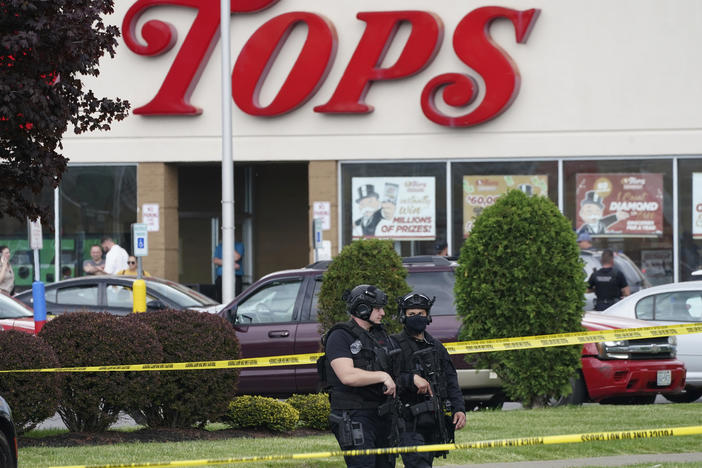 Police secure an area around a supermarket where several people were killed in a shooting, Saturday, May 14, 2022, in Buffalo, N.Y.
