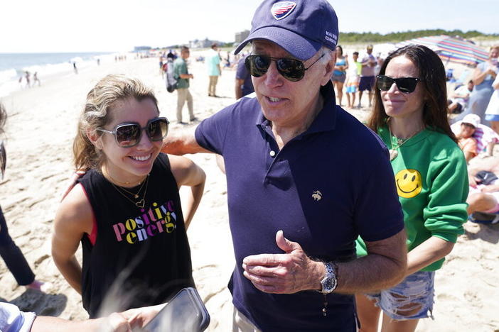 President Joe Biden talks to the media after walking on the beach Monday with his granddaughter Natalie Biden, left, and his daughter Ashley Biden at Rehoboth Beach, Del.