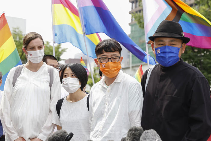 Plaintiffs speak to journalists after a court ruling in Osaka, western Japan Monday, June 20, 2022.