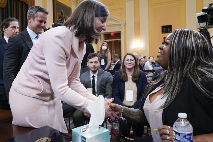 Rep. Elaine Luria, D-Va., greets Wandrea "Shaye" Moss, a former Georgia election worker, after she testified at the House select committee investigating the Jan. 6 insurrection on Tuesday as committee members Reps. Adam Kinzinger, R-Ill., and Jamie Raskin, D-Md., wait their turn.