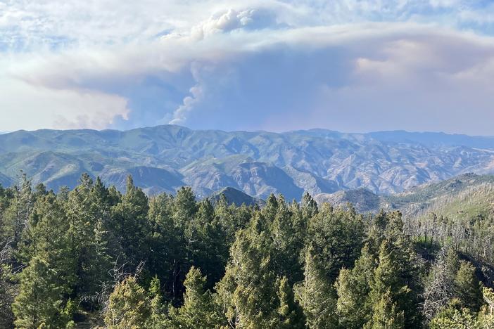 A plume of smoke from the Black Fire rises over the Gila National Forest. Philip Connors watched the fire grow and creep closer to his fire lookout post.