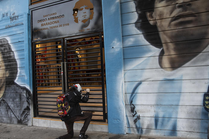 A man prays in front of a sanctuary for the late soccer star Diego Maradona at Argentinos Juniors stadium in Buenos Aires, Argentina, last November.