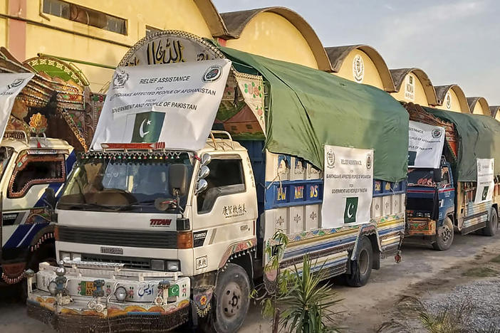 In this photo released by Pakistan's National Disaster Management Authority, a convoy of trucks carrying relief goods prepare to leave for Afghanistan at a warehouse in Islamabad, Pakistan, Thursday, June 23, 2022.