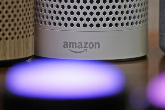 Amazon Echo and Echo Plus devices behind illuminated Echo Button devices during an event by the company in Seattle in September 2017.
