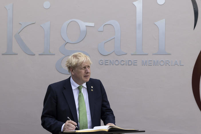 British Prime Minister Boris Johnson signs the visitors book while visiting the Kigali Genocide Memorial in Kigali, Rwanda, Thursday June 23, 2022.