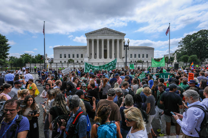 Abortion rights demonstrators hold signs outside the Supreme Court in Washington, D.C., on Friday.