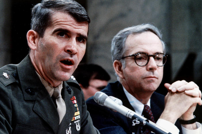 Marine Corps Lt. Col. Oliver North, accompanied by his lawyer Brendan Sullivan, was a central figure in the Iran-Contra hearings.