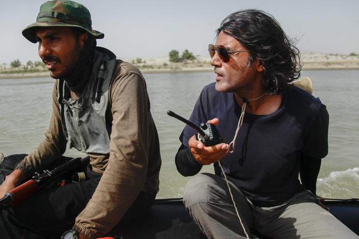 Wajahat Malik, right, and a Pakistan Navy seaman navigate the Indus River. Malik organized a 40-day expedition down the 2,000-mile river to document "the peoples, the cultures, the biodiversity and just whatever comes our way," he says — including the impact of climate change and pollution.