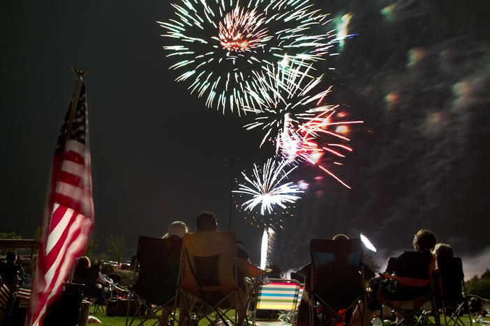 Spectators watch as fireworks explode overhead during the Fourth of July celebration at Pioneer Park, on July 4, 2013, in Prescott, Ariz.