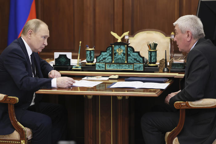 Russian President Vladimir Putin meets with the head of Russia's Federal Financial Monitoring Service, Yury Chikhanchin, at the Kremlin in Moscow on Monday.