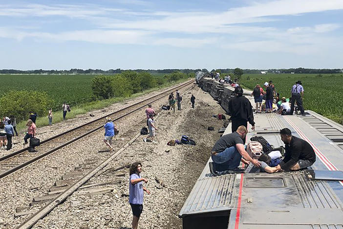 An Amtrak passenger train lies on its side after derailing near Mendon, Mo., on Monday.