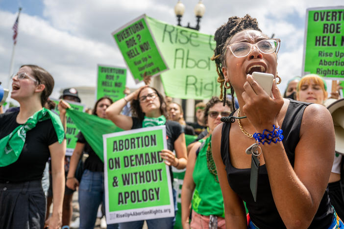 Abortion rights demonstrator Elizabeth White leads a chant in response to the Dobbs v. Jackson Women's Health Organization ruling in front of the U.S. Supreme Court on June 24, 2022.