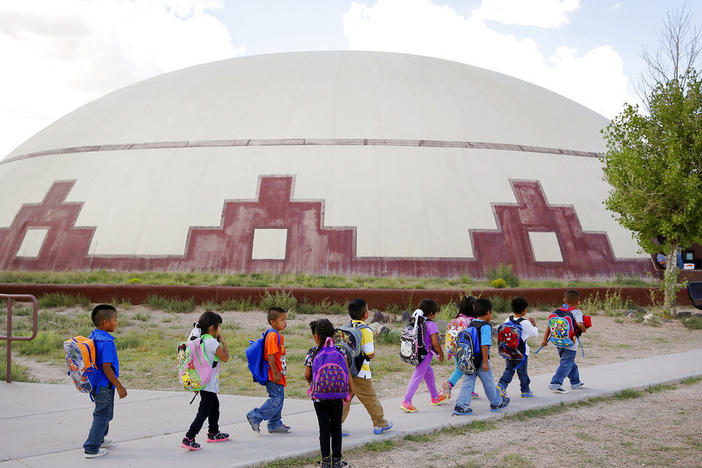 Students walk between buildings in September 2014 at the Little Singer Community School in Birdsprings, Ariz., on the Navajo Nation.