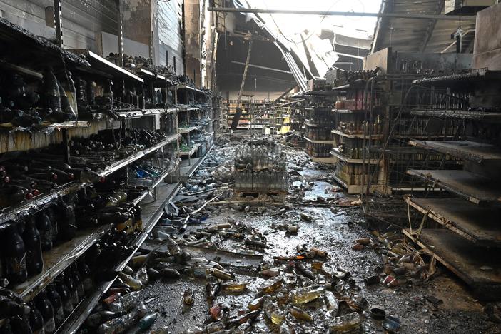 A photograph taken Tuesday shows charred goods in a grocery store of the destroyed Amstor mall in Kremenchuk, central Ukraine, one day after it was hit by a Russian missile strike.