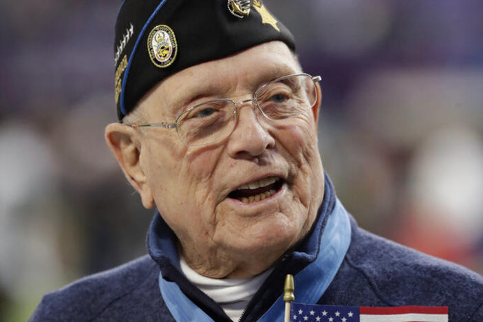 Woody Williams assists with the coin toss before Super Bowl 52 in February 2018 in Minneapolis. Williams, the last remaining Medal of Honor recipient from World War II, died Wednesday at 98, at the Veterans Affairs medical center bearing his name in Huntington, W.Va.