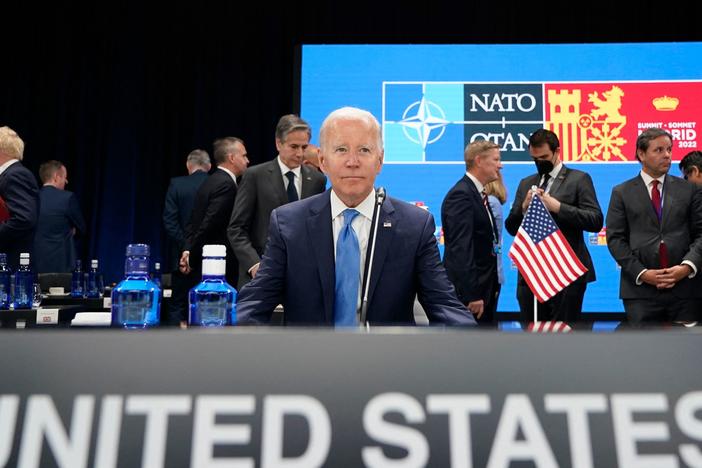 President Biden waits for the start of a roundtable meeting at the NATO summit in Madrid. He announced the U.S. would increase its military presence in Europe.