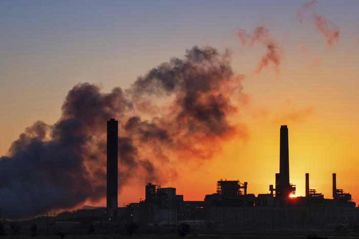 In this July 27, 2018 photo, the Dave Johnson coal-fired power plant is silhouetted against the morning sun in Glenrock, Wyo.
