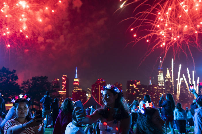 Spectators watch as fireworks are launched over the East River and the Empire State Building in New York City on July 4, 2021. Regulators are warning people ahead of July Fourth to be careful handling any recreational fireworks.