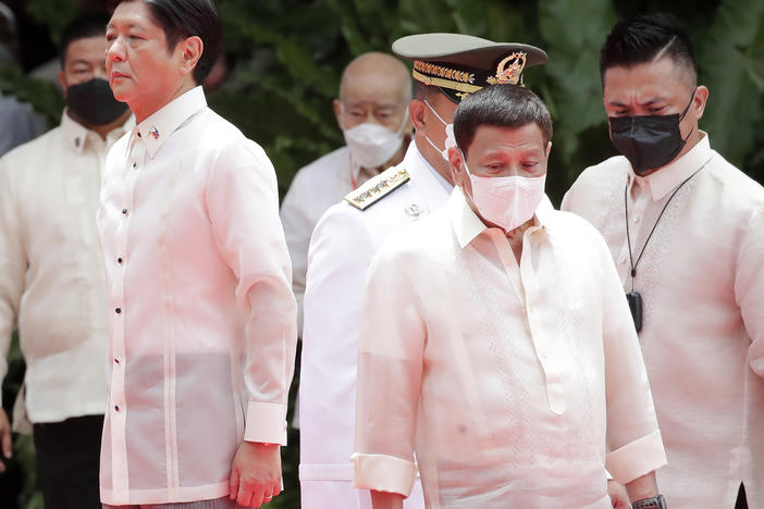 Incoming Philippine president Ferdinand Marcos Jr., left, and outgoing President Rodrigo Duterte, right, attend Marcos' inauguration ceremony in Manila, Philippines, Thursday, June 30, 2022.