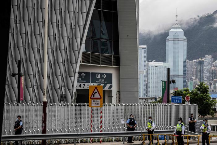 Police guard a closed road outside the Xiqu Centre in Hong Kong on June 30, 2022, as Chinese President Xi Jinping arrives in Hong Kong to attend celebrations marking the 25th anniversary of the city's handover from Britain to China.