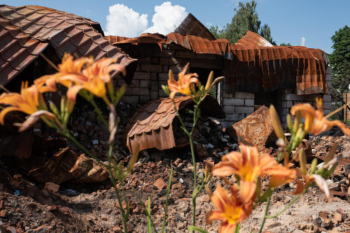 A destroyed building next to flowers on Thursday in Borodianka, Ukraine. The region around Ukraine's capital continues to recover from Russia's aborted assault on Kyiv, which turned many communities into battlefields.