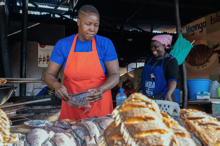 Florence Aluoch Odero prepares fish for frying at Migingo Island Hotel, a food stall in Nairobi's Kenyatta Market. Her expenses are soaring due to inflation.