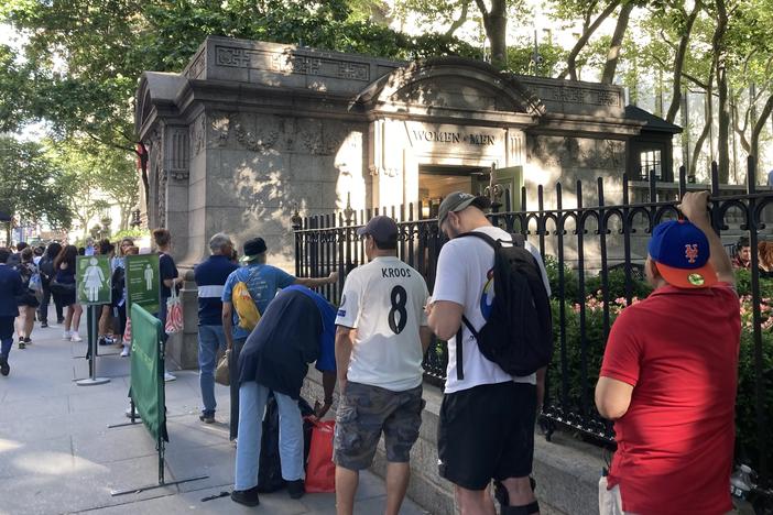 People wait in line to use a public restroom at Bryant Park, in midtown Manhattan, on June 28.