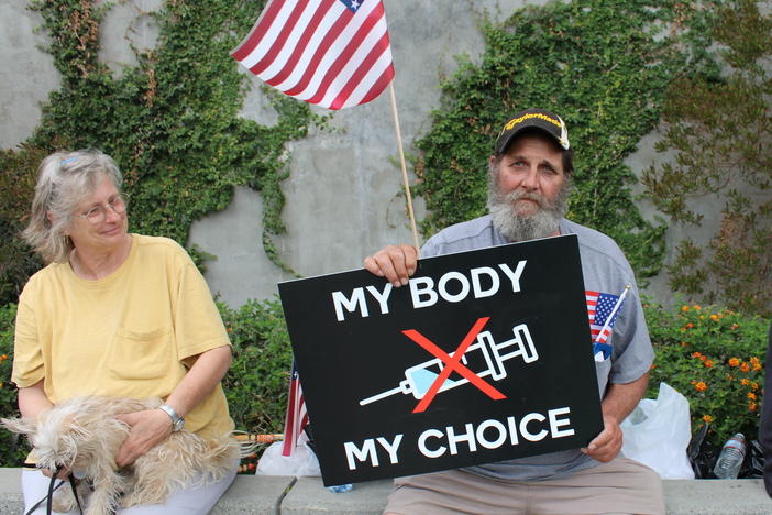 Steve Bova (center) traveled from Maryland to Los Angeles with the "People's Convoy" to protest covid-19 restrictions. Despite using a phrase that originated with the abortion rights movement, he opposes abortion.