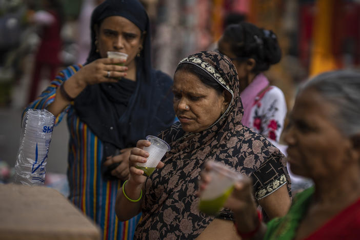 Shoppers drink juice in plastic cups at a market in New Delhi, on Wednesday. India banned some single-use or disposable plastic products Friday as part of a longer plan to phase out the ubiquitous material in the nation of nearly 1.4 billion.